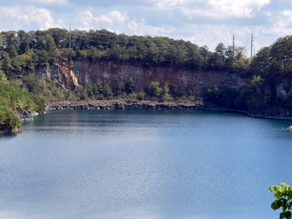 The cut granite face across the water.