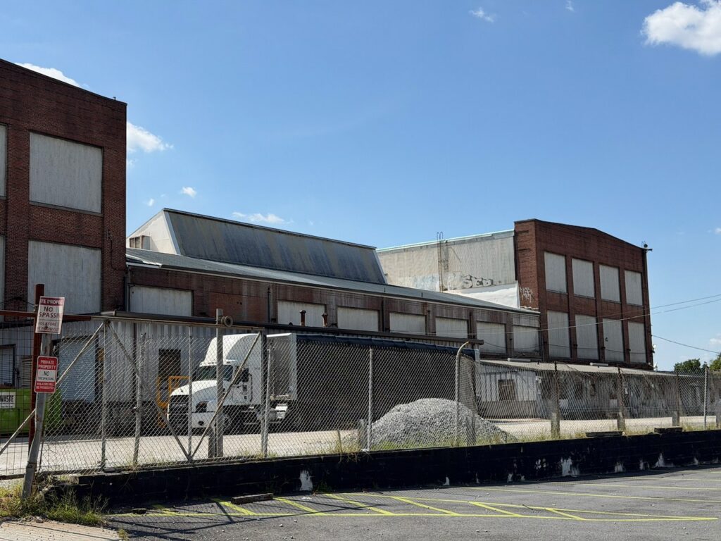 The sheds behind the main block, along the fence.