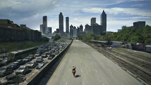 Rick rides down Freedom Parkway into Atlanta, the outbound lanes jammed with the cars that fled.