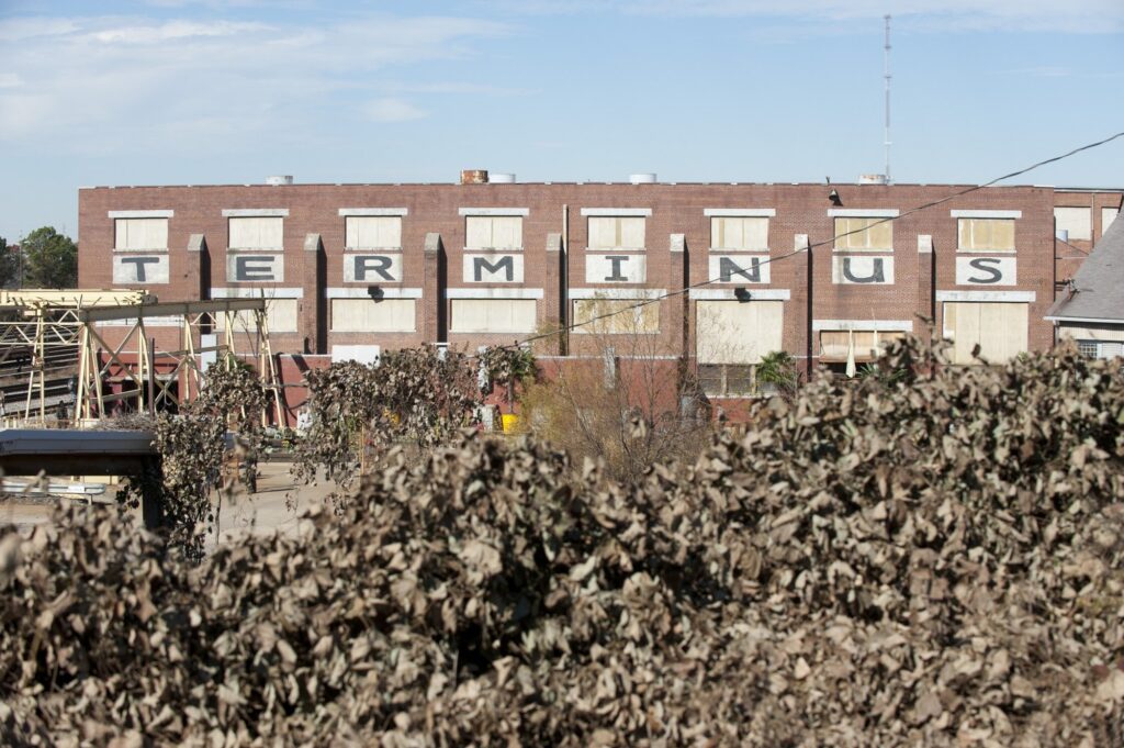 The TERMINUS letters close up, on the top row of windows of the rail-yard face.